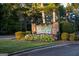 Landscaped entrance to Fairfield Plantation with stone signage and colorful flower beds at 1190 Plantation Dr, Villa Rica, GA 30180