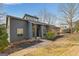 Contemporary home with stone accents, mature trees, and manicured lawn at 1190 Plantation Dr, Villa Rica, GA 30180