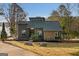 Charming modern home with stone accents and landscaped front yard, perfect for lakeside living at 1190 Plantation Dr, Villa Rica, GA 30180
