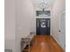 Bright entryway with hardwood floors, chandelier, and decorative front door at 1190 Plantation Dr, Villa Rica, GA 30180