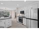 Modern kitchen with white cabinets, stainless appliances, granite countertops, and open dining area view at 1190 Plantation Dr, Villa Rica, GA 30180