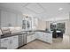 Bright modern kitchen features white cabinets, stainless steel appliances, and a view into the dining area at 1190 Plantation Dr, Villa Rica, GA 30180
