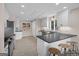 Modern kitchen features sleek white cabinets, dark countertops, stainless steel appliances, and bar seating at 1190 Plantation Dr, Villa Rica, GA 30180