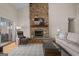 Cozy living room with stone fireplace, comfortable seating, and a view of the lake at 1190 Plantation Dr, Villa Rica, GA 30180