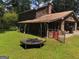View of a backyard and trampoline with an exterior of the house at 963 Blackberry Ct, Ellenwood, GA 30294