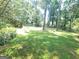 Large backyard with mature trees, shed, and plenty of space for outdoor activities at 963 Blackberry Ct, Ellenwood, GA 30294
