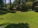 View of a green back yard with scattered trees at 963 Blackberry Ct, Ellenwood, GA 30294