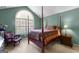 Tranquil bedroom with a four-poster bed and arched window at 275 Rehobeth Way, Fayetteville, GA 30214