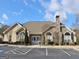 Well-maintained clubhouse exterior with stone accents, flagpole, ample parking, and landscaped grounds at 275 Rehobeth Way, Fayetteville, GA 30214