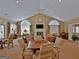 Spacious clubhouse interior with a fireplace, seating area, dining tables, and large windows at 275 Rehobeth Way, Fayetteville, GA 30214