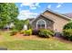 Home exterior with stone and siding details, surrounded by manicured landscaping and lush greenery at 275 Rehobeth Way, Fayetteville, GA 30214