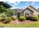 Charming home exterior with stone accents, complemented by lush landscaping and a welcoming pathway at 275 Rehobeth Way, Fayetteville, GA 30214
