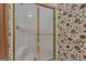 Bathroom featuring floral wallpaper, a shower with a glass door, and a gold towel bar at 390 Stoneridge Way, Fayetteville, GA 30215