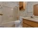Bathroom featuring a shower and tub combination, wood vanity, and floral wallpaper at 390 Stoneridge Way, Fayetteville, GA 30215