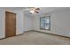 Carpeted bedroom featuring a ceiling fan, window unit, natural light, and a door at 390 Stoneridge Way, Fayetteville, GA 30215