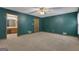 View of a large bedroom featuring neutral carpet, ceiling fan, a glimpse into en-suite bathroom, and natural light at 390 Stoneridge Way, Fayetteville, GA 30215