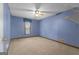 Bedroom with blue walls, neutral carpet, ceiling fan, and a window with natural light at 390 Stoneridge Way, Fayetteville, GA 30215