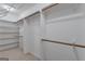 Walk-in closet with white walls and shelves, and neutral carpet at 390 Stoneridge Way, Fayetteville, GA 30215