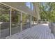 Spacious deck with multiple sliding glass doors offering serene views of lush greenery and access to the house at 390 Stoneridge Way, Fayetteville, GA 30215