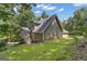 Two-story home showcasing a well-manicured lawn, covered parking, and mature trees adding to its charm at 390 Stoneridge Way, Fayetteville, GA 30215