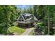 Secluded two-story home nestled among mature trees, featuring a spacious deck and a serene setting at 390 Stoneridge Way, Fayetteville, GA 30215