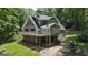 Charming two-story home with a large deck, surrounded by lush greenery and a well-maintained yard at 390 Stoneridge Way, Fayetteville, GA 30215