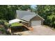Exterior features a garage, driveway, and covered parking at 390 Stoneridge Way, Fayetteville, GA 30215