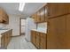 Galley kitchen featuring white appliances, light countertops, and wood cabinetry at 390 Stoneridge Way, Fayetteville, GA 30215