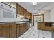 Traditional kitchen showcases wood cabinets, white appliances, and black-and-white tile flooring at 390 Stoneridge Way, Fayetteville, GA 30215