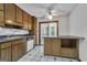 View of the traditional kitchen with wooden cabinetry, white appliances, and black-and-white tile flooring at 390 Stoneridge Way, Fayetteville, GA 30215