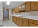 Galley kitchen featuring white appliances, light countertops, and wood cabinetry at 390 Stoneridge Way, Fayetteville, GA 30215