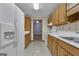 Galley kitchen featuring white appliances, light countertops, and wood cabinetry at 390 Stoneridge Way, Fayetteville, GA 30215