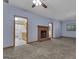 Living room with brick fireplace and view into kitchen at 390 Stoneridge Way, Fayetteville, GA 30215