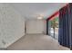 Large living room with sliding doors leading to a deck and floral wallpaper at 390 Stoneridge Way, Fayetteville, GA 30215