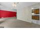 Open living space with carpeted floors, wallpaper, and a doorway to the kitchen at 390 Stoneridge Way, Fayetteville, GA 30215