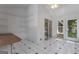 Sunroom with white walls and black-and-white tile flooring, offering plenty of natural light at 390 Stoneridge Way, Fayetteville, GA 30215