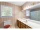 Bathroom featuring a vanity with storage space, toilet, and shower-tub combo at 829 Bev Ct, Lawrenceville, GA 30046
