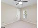 This bedroom features neutral walls and carpeting, a window with blinds, and a ceiling fan at 829 Bev Ct, Lawrenceville, GA 30046