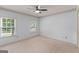 Bedroom features carpeted floors, two windows offering natural light, and a ceiling fan at 829 Bev Ct, Lawrenceville, GA 30046