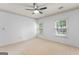 Bedroom features carpeted floors, two windows offering natural light, and a ceiling fan at 829 Bev Ct, Lawrenceville, GA 30046