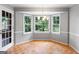 Sun-drenched dining area features hardwood floors, bay window, and modern chandelier at 829 Bev Ct, Lawrenceville, GA 30046