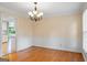 Traditional dining room with classic wainscoting, hardwood floors, and elegant chandelier at 829 Bev Ct, Lawrenceville, GA 30046