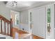 Inviting foyer with a white door, hardwood floors, and a staircase to the upper level at 829 Bev Ct, Lawrenceville, GA 30046