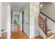 Hallway featuring hardwood floors, a staircase, and white trim at 829 Bev Ct, Lawrenceville, GA 30046