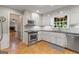 Well-equipped kitchen featuring white cabinets, stainless steel appliances, and views of the backyard at 829 Bev Ct, Lawrenceville, GA 30046