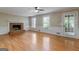 Bright living room with hardwood floors, fireplace, and views of the backyard at 829 Bev Ct, Lawrenceville, GA 30046