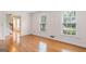 Sunlit living room with hardwood floors and a view into the entryway at 829 Bev Ct, Lawrenceville, GA 30046