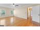 Spacious main bedroom featuring hardwood floors, ceiling fan, and access to ensuite bathroom and walk-in closet at 829 Bev Ct, Lawrenceville, GA 30046
