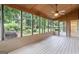 Screened-in porch features wooded views, ceiling fan, and access to the backyard at 829 Bev Ct, Lawrenceville, GA 30046