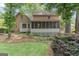 Rear exterior brick home featuring a screened porch and backyard with lawn at 829 Bev Ct, Lawrenceville, GA 30046